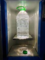 A bottle of refreshing water is currently positioned on a shelf in a vending machine, eagerly waiting to be chosen and savored by a thirsty customer in need of essential hydration photo