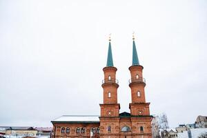 The impressive brick building, known for its unique architecture, features two towering structures that enhance its grandeur and contribute to the citys captivating skyline photo