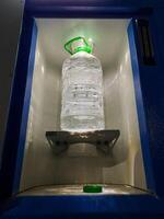 An impressive Water Dispenser that features a large, clear plastic bottle placed conveniently in a builtin cooling chamber for optimal freshness photo