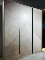 In a spacious and beautifully designed room, there stands a large wooden wardrobe featuring sliding doors that not only adds function but also brings an elegant touch to the overall decor photo