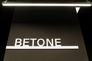 A rectangular sign with a unique font reading betone serves as a branding communication device for events. Its a multimedia display gadget creating a strong brand impact photo