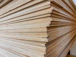 This closeup image shows a neatly stacked pile of plywood sheets, highlighting the intricate textures and patterns of this essential material used in construction and design photo