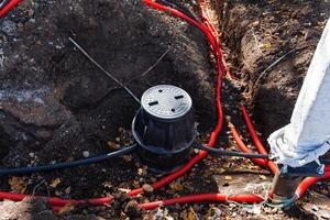 An innovative Underground Water Management System utilizing Red PVC Pipes and a Connector Box for effective water flow and management photo