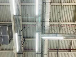 The ceiling features numerous lights that are elegantly suspended from its surface, creating a vibrant and illuminated atmosphere in the room, enhancing its overall aesthetic appeal photo