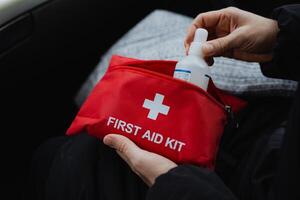 A person stands confidently while holding a first aid kit, demonstrating their calm assurance and readiness to assist in emergencies, prioritizing the safety and wellbeing of those in need photo