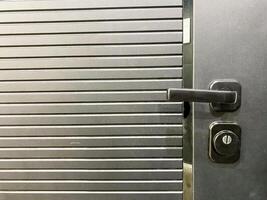 This is a closeup image that showcases a door with a distinct handle attached to it, allowing for easy opening and closing. Its a common fixture found in various settings photo
