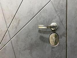 The Modern Door Handle and Lock feature a Stylish Design with Textured Door, perfect for enhancing security and aesthetics in contemporary architecture and home decor photo