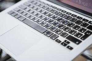 This image presents a closeup of a laptop keyboard on a table, highlighting its keys, layout, and design, offering insight into modern computing technology and its functions photo
