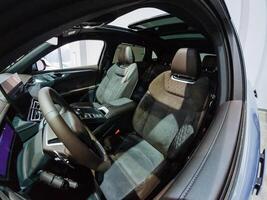 The inside of a car with the sunroof open photo