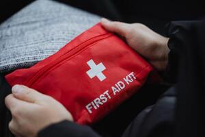 An essential First Aid Kit equipped with a convenient Portable Red Bag, perfect for use in any emergency situation or location that may arise photo
