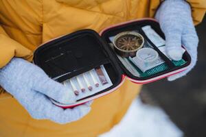 Essential Adventure Kit A collection of Survival Tools and a reliable Compass specifically designed for Outdoor Enthusiasts exploring in a snowy landscape and environment photo