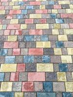 The intricately designed brick pavement enhances the cityscape with vivid colors, symmetry, and charm, elevating its visual appeal and artistic value with its carefully crafted pattern photo