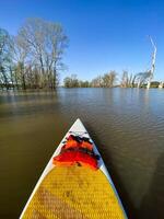 Experience paddleboarding on peaceful waters in a serene environment, surrounded by natures beauty and calm atmosphere photo