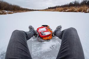 Enjoying an exhilarating ice fishing adventure involves not only relaxing on the expansive frozen water but also utilizing specialized gear amidst a stunning winter landscape photo