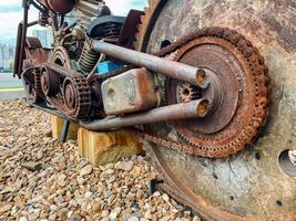 A detailed closeup view of a rusty piece of metal sitting on a rocky surface, showcasing the intricate textures and hues of the rust against the backdrop of the rugged rocks photo