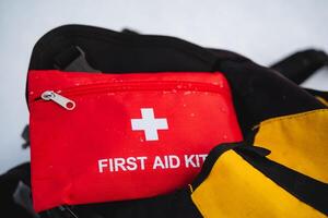 A vibrant red first aid kit that prominently showcases a distinct white cross symbol on its surface, ensuring easy identification and quick accessibility during emergencies when needed photo