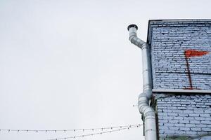 The structure is a substantial brick building with a vibrant red flag painted on its exterior, making it a prominent landmark easily noticeable from nearby points of interest photo