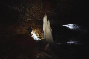 Embarking on an enthralling adventure into an icecovered cave reveals a mysterious journey filled with natures stunning ice sculptures photo