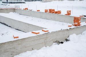 At the construction site, theres an impressive amount of snow covering the ground, creating a winter wonderland that stands in contrast to the construction equipment around photo
