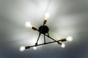 This image captures a detailed closeup view of a beautifully designed light fixture that is elegantly hanging down from the ceiling, creating a nice ambience in the room photo