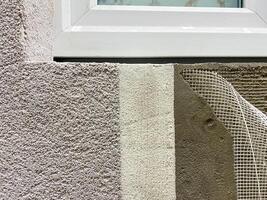 A beautifully detailed closeup of a window being meticulously and carefully installed on a long wall, showcasing the incredible craftsmanship and precision of the skilled work being done photo