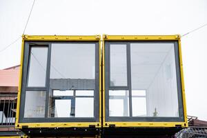 A vibrant yellow building with large, expansive windows is currently under construction, showcasing its impressive modern design and unique architectural features that stand out beautifully photo
