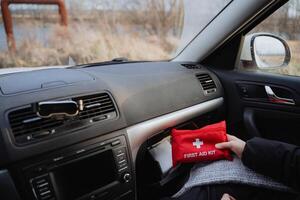 Having an Essential First Aid Kit neatly organized in a Cars Dashboard is crucial for maintaining Safety on the Road during emergencies photo