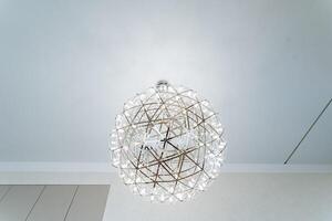 The room has a beautiful chandelier that enhances the cozy atmosphere with soft light, creating a welcoming ambiance. The elegant fixture adds art and elegance to the space photo