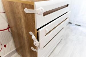 This is a detailed closeup view of a beautifully crafted dresser, featuring secure locks on each of its drawers for added safety and privacy. An elegant piece of furniture, indeed photo