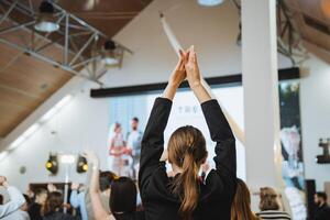 Group of people in room sharing high fives as a gesture after fun event photo
