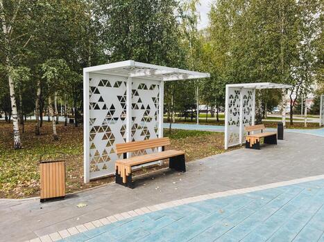 allí es un hermosa parque presentando un largo fila de bancos dónde visitantes lata sentar y relajarse, a lo largo con un convenientemente metido basura lata para mantener limpieza en el zona foto