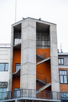 A tall structure featuring a set of stairs that ascend all the way to the top, making it accessible for people to reach the various levels of the building safely and conveniently photo