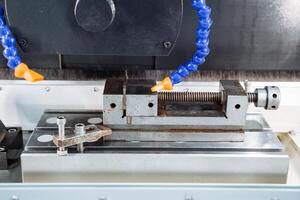 This advanced machine features a sturdy vise and an attached water hose, offering multiple functionalities and exceptional versatility across various fields and industries photo