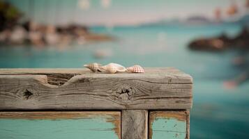 Closeup of Seashells on Rustic Wooden Surface with Turquoise Coastal Ocean in the Background photo