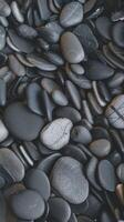 Smooth Black and Gray Pebbles Overlapping in Natural Pattern with Subtle Texture Perfect for Zen or Spa Themes photo