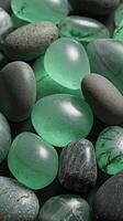 Smooth Polished Green and Dark Stones in Close-Up with Natural Texture on Dark Background photo