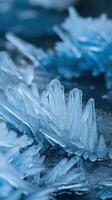 Closeup of Abstract Blue Ice Crystal Formations on Dark Background Representing Winter and Cold photo