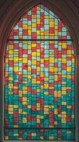 Vibrant Multicolored Stained Glass Window With Geometric Design In Gothic Arch Frame photo