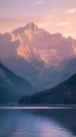 Majestic Pink Mountains with Forest Reflections in Calm Lake at Sunrise under Soft Sky photo