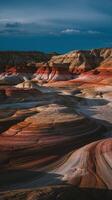 Dramatic Sandstone Rock Formations with Red and White Layers Under Dark Evening Sky in Desert Landscape photo