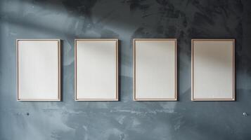 Four Blank Framed Canvas Artworks on Moody Gray Textured Wall with Natural Light Shadows photo