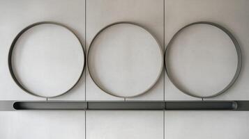 Minimalist Modern Wall Design With Three Circular Metal Frames On Neutral Gray Background photo