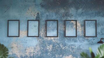 Empty Black Picture Frames on Vintage Textured Blue Wall with Abstract Design and Indoor Plants photo