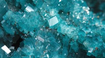 Detailed Closeup of Vibrant Teal Crystals with Reflective Geometric Shapes and Sparkling Texture photo