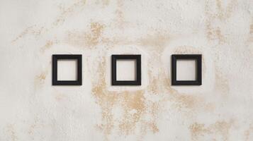 Three Empty Black Square Frames on Vintage Beige Textured Wall with Rustic Aesthetic Background photo