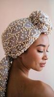 Side Profile of Woman Wearing Elegant Pearls Decorated Head Wrap Against Light Neutral Background photo