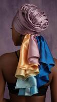 Woman Wearing Lavender Headwrap with Multicolored Satin Ribbons against Purple Background photo