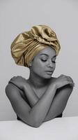 Serene Woman with Gold Satin Headwrap Posing Against Minimalist Gray Background in Thoughtful Expression photo