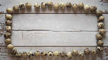 Rustic Wooden Background with Symmetrically Arranged Spotted Quail Eggs in Rectangular Frame Shape photo