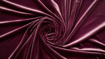 Deep Burgundy Velvet Fabric with Smooth Spiral Fold Pattern Symbolizing Luxury and Elegance photo